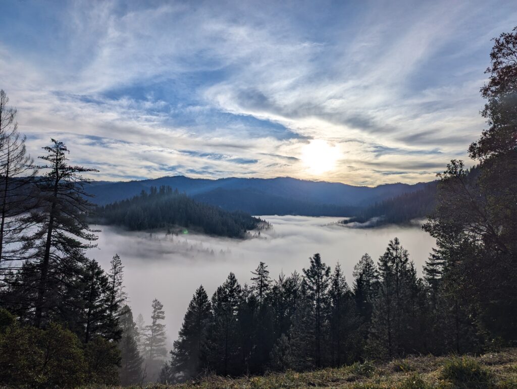Sunrise over a fog-filled valley